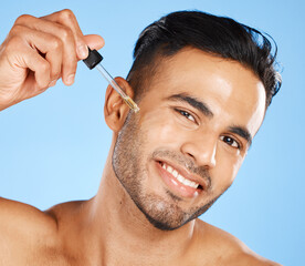 Man face, skin serum or beard oil of facial hair growth beauty product on blue studio background....