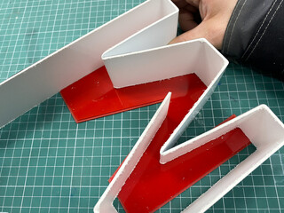 Production of a three-dimensional outdoor advertising logo.Gluing an acrylic letter with cyanoacrylate glue. Production of interior advertising.