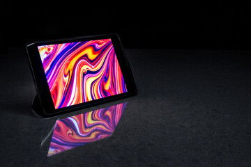 Digital Tablet with a Colorful Screen on a Black Background