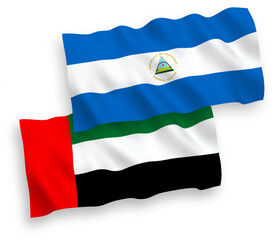 National vector fabric wave flags of Nicaragua and United Arab Emirates isolated on white background. 1 to 2 proportion.