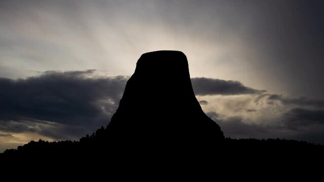 Sunrise at Devil's Tower in Wyoming, Time Lapse with Fast Clouds and Dark Silhouette of National Monument, USA