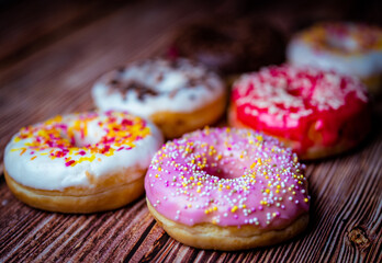 several donuts lined up on a table with a soft bokeh