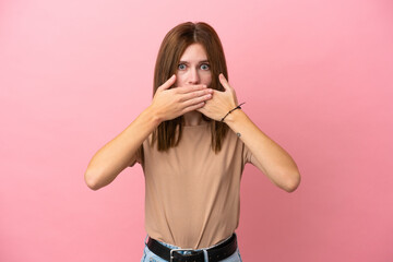 Young English woman isolated on pink background covering mouth with hands