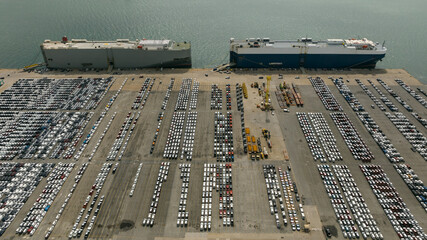 Large RoRo (Roll-on Roll-off) into Commercial dock loading new car product order for sale for export international on the sea, business service transportation concept