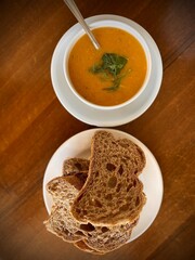 Fresh amazing air soft bread and lentil soup. Traditional turkey lunch food. Beautiful appetites bakery background. Wooden table.

