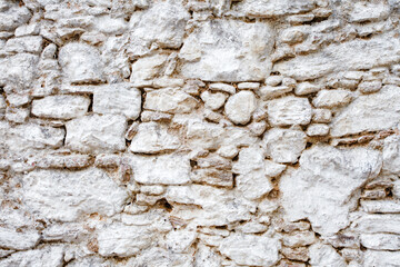 Wall old made of big crooked broken stones, rough blocks  background.