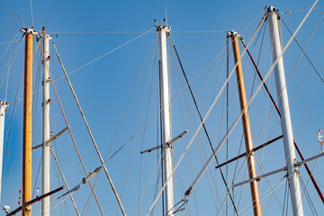 Masts tops and rigging on yachts sailing vessels in the marina