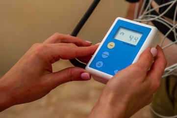 Electrocardiogram, ECG in hand. Clinic of Cardiology heart rate and pulse test closeup.
