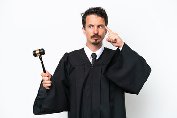 Young judge caucasian man isolated on white background having doubts and thinking