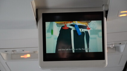 LCD Screen in Airplane with movie explanation. Passenger plane interior with informational screen