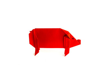 red paper pig on a white background. origami.