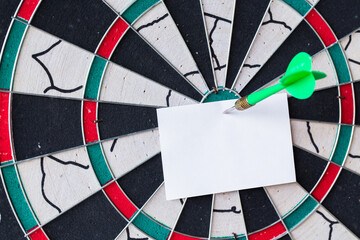 Business concept. darts arrows in the target center with paper note for Writing goals for this...