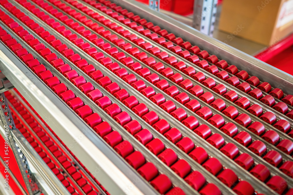 Poster conveyor for goods. surface of conveyor line. production line with small rollers. multi-tier conveyo