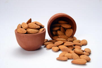 Fresh almonds in the wooden bowl, Organic almonds, almonds border white background, Almond nuts on a dark wooden background. Healthy snacks. Top view. Free space for text.