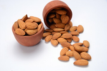 Fresh almonds in the wooden bowl, Organic almonds, almonds border white background, Almond nuts on a dark wooden background. Healthy snacks. Top view. Free space for text.