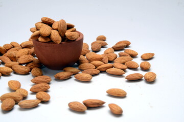 Fresh almonds in the wooden bowl, Organic almonds, almonds border white background, Almond nuts on a dark wooden background. Healthy snacks. Top view. Free space for text.