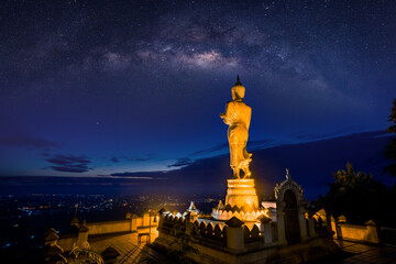 Statue of buddha with milky way in background, Wat Phra That Khao Noi, Nan province, Thailand.