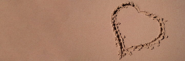 Heart is painted on sand of sea beach closeup