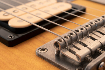 Detail of the bridge saddles of an electric guitar with selective focus