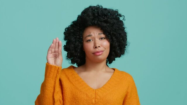 African American Girl annoyed with talktative coworkers always gossiping, never shut their mouths. Slow motion irritated and tired woman showing talking hand gesture, saying blah blah on background