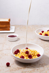 Splash of milk in cereal bowl