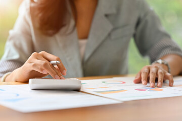 Close up with Businesswoman's hands using calculate expenses expenditures, manage budget, analysis data charts and graphs, Business finances and  and accounting concept.