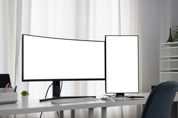 Workspace with curved-screen computer design and vertical monitor on the office desk.