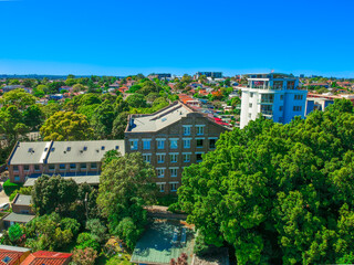 Fototapeta na wymiar Panoramic Aerial Drone view of Suburban Sydney housing, roof tops, the streets and the parks