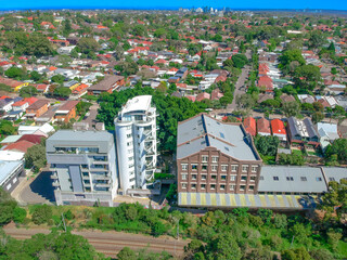 Obraz premium Panoramic Aerial Drone view of Suburban Sydney housing, roof tops, the streets and the parks