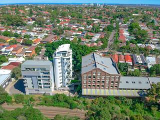 Obraz premium Panoramic Aerial Drone view of Suburban Sydney housing, roof tops, the streets and the parks