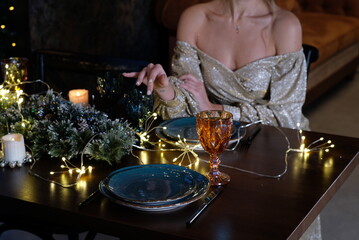 a luxurious woman at a served table is waiting for a partner