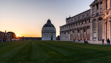 Large park, the Baptistery and the Cathedral of Pisa at sunset. Italy
