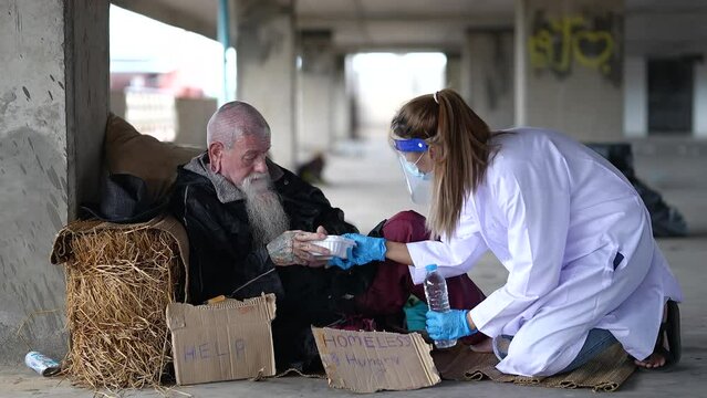 Health workers provide assistance to the homeless. homeless poor people depression Help and hope concept.