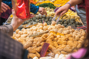 Taiwanese traditional sweet sesame balls with a peanut flavour tag in mandarin at Chinese New Year...
