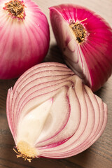 two red onions close up on wooden background