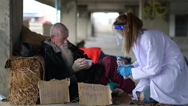 Health workers provide assistance to the homeless. homeless poor people depression Help and hope concept.