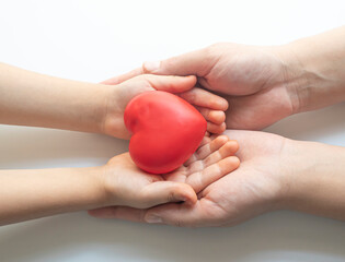 boy holding white heart in palm. Organ donation and insurance concept. World heart health concept....