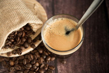 Coffee cup with coffee beans on dark background. Copy Space.