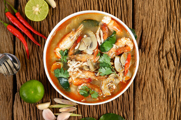 Tom Yum hot spicy soup on wooden background