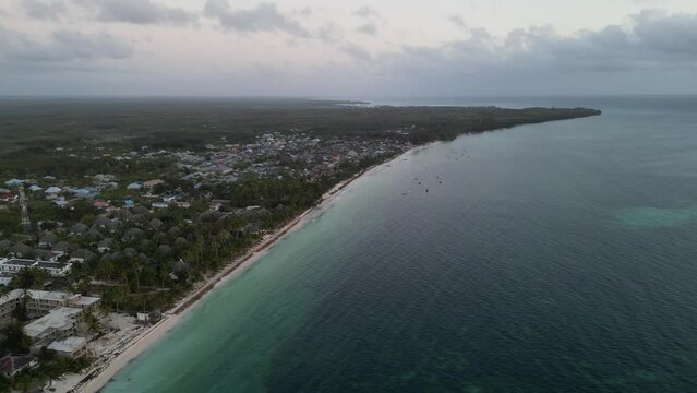 Beach resorts and homes in Uroa Beach Zanzibar Island, Tanzania Africa, Aerial pan right shot