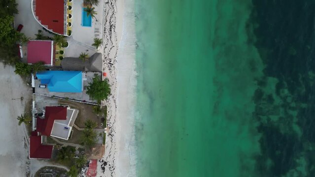 Uroa beach resorts and homes in Zanzibar Island Tanzania Africa, Aerial top view dolly up shot