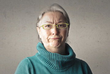 portrait of elderly lady with doubtful expression - obrazy, fototapety, plakaty