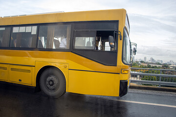 Fototapeta na wymiar The city bus ride on a wet road