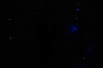 Small yellow and blue light bulbs in complete darkness