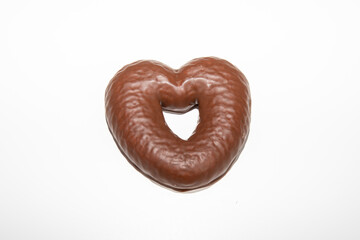 Gingerbread heart biscuit covered in chocolate and isolated on white background