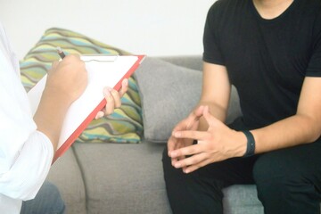 psychologist taking notes and thoughtful patient