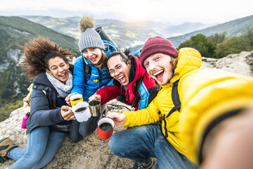 Multiracial group of young people hiking mountains together - Happy friends taking selfie picture...