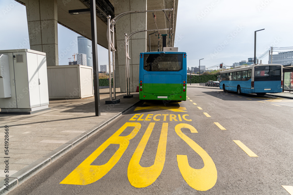 Sticker Electric bus at a stop is charged by pantograph