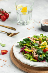 Salad with tuna, lettuce, cherry tomatoes, avocado and red onions. superfood concept. Healthy, clean eating concept. Vegan or gluten free diet. Top view
