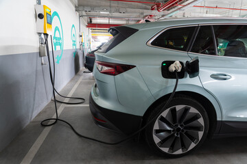 Electric cars are charged from the charging station in the indoor parking of the shopping center